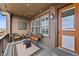 Inviting porch with wicker furniture, string lights, and an orange front door at 4475 Hidden Gulch Rd, Castle Rock, CO 80104