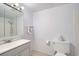 Well-lit bathroom features a shower/tub combo, modern sink, and neutral tile flooring at 12174 Melody Dr # 203, Westminster, CO 80234