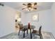 Bright dining area features a modern ceiling fan, a dark wood table and seating for two at 12174 Melody Dr # 203, Westminster, CO 80234