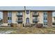 Exterior of multi-Gathering unit with balconies, stone columns, and winter landscaping at 12174 Melody Dr # 203, Westminster, CO 80234