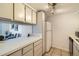 Well-lit kitchen with white counters, ample storage, and modern appliances at 12174 Melody Dr # 203, Westminster, CO 80234