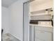 Convenient laundry room with stacked washer and dryer and built-in shelving at 12174 Melody Dr # 203, Westminster, CO 80234