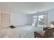 Bright living room with carpet, slider door leading to the outside, and cozy seating area at 12174 Melody Dr # 203, Westminster, CO 80234