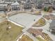 Aerial view of a fenced basketball court with benches surrounded by landscaping and accessible by paved walkways at 9028 S Catawba St, Aurora, CO 80016