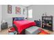 This bedroom offers a colorful rug, grey walls, natural light, and is decorated with posters and collectables at 9028 S Catawba St, Aurora, CO 80016