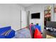 This secondary bedroom includes a large mounted television, a desk, and a closet for storage at 9028 S Catawba St, Aurora, CO 80016