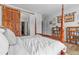 Inviting bedroom showcases a wooden four-poster bed, a sliding barn door, and ample closet space at 9028 S Catawba St, Aurora, CO 80016