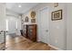 Welcoming entryway with hardwood floors, decorative lighting, and charming wall decor at 9028 S Catawba St, Aurora, CO 80016