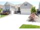 Charming two-story home featuring a three-car garage, well-manicured lawn, and neutral-toned siding at 9028 S Catawba St, Aurora, CO 80016