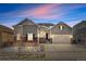 Charming gray two-story home with a two-car garage and inviting curb appeal at dusk at 9028 S Catawba St, Aurora, CO 80016
