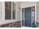 Welcoming front entrance featuring a stylish blue door, stone accents, and ample natural light at 9028 S Catawba St, Aurora, CO 80016