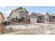 Inviting home exterior with a two-car garage, stone accents, and a landscaped front yard at 9028 S Catawba St, Aurora, CO 80016