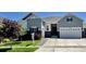 Charming two-story home featuring manicured lawn, gray siding, and a two-car garage, and professional landscaping at 9028 S Catawba St, Aurora, CO 80016