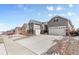 Charming two-story home showcasing a three-car garage, stone accents, and a well-maintained front yard at 9028 S Catawba St, Aurora, CO 80016