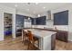 Modern kitchen boasts stainless steel appliances, custom cabinets, granite countertops, and a center island with seating at 9028 S Catawba St, Aurora, CO 80016