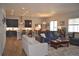 Open-concept living room with modern kitchen, dining area, and comfortable seating, creating a spacious and inviting atmosphere at 9028 S Catawba St, Aurora, CO 80016