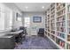 Bright office space featuring custom built-in bookshelves, a desk, and a comfortable chair at 9028 S Catawba St, Aurora, CO 80016