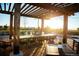 Outdoor dining and gathering area with a pergola and string lights at 9028 S Catawba St, Aurora, CO 80016
