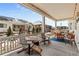 Covered patio with outdoor seating provides a cozy space for relaxing and entertaining with views of a landscaped yard at 9028 S Catawba St, Aurora, CO 80016