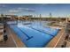 Bright swimming pool with lane markers, lounge chairs, pergolas, and landscaping at 9028 S Catawba St, Aurora, CO 80016