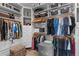 Walk-in closet featuring custom shelving, hanging rods, and a comfortable storage bench at 9028 S Catawba St, Aurora, CO 80016
