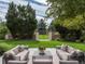 Secluded backyard oasis featuring lush landscaping and comfortable seating area, perfect for relaxing at 18 Foxtail Cir, Englewood, CO 80113