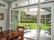 French doors opening onto a patio and lush backyard with manicured landscaping at 18 Foxtail Cir, Englewood, CO 80113
