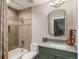 Bathroom featuring a vanity with a green cabinet and a combination shower and bathtub at 18 Foxtail Cir, Englewood, CO 80113