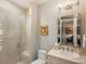 Bright bathroom featuring a glass enclosed shower and vanity at 18 Foxtail Cir, Englewood, CO 80113