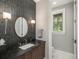 Stylish powder room with modern fixtures and dark vanity at 18 Foxtail Cir, Englewood, CO 80113
