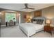 Bedroom with a ceiling fan, a desk by the window, and a bed with decorative pillows at 18 Foxtail Cir, Englewood, CO 80113