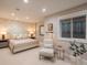 Serene bedroom featuring a patterned accent wall, stylish furniture, and natural light at 18 Foxtail Cir, Englewood, CO 80113