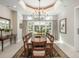 Bright dining room with a chandelier, large windows overlooking the backyard, and elegant decor at 18 Foxtail Cir, Englewood, CO 80113