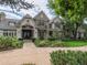 Stunning two-story home with stone accents, lush landscaping, and a welcoming entrance at 18 Foxtail Cir, Englewood, CO 80113