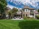 Exterior view of a beautiful house with manicured lawn and outdoor patio, ideal for gatherings and entertaining at 18 Foxtail Cir, Englewood, CO 80113