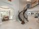 Grand foyer features a spiral staircase and views of the dining room at 18 Foxtail Cir, Englewood, CO 80113