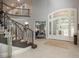 Elegant foyer features curved staircase, and a stylish front entrance at 18 Foxtail Cir, Englewood, CO 80113