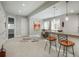 Bright and airy kitchen with a large island, bar stools, and ample natural light at 18 Foxtail Cir, Englewood, CO 80113