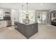 Open kitchen with center island, breakfast bar, and access to the dining area at 18 Foxtail Cir, Englewood, CO 80113