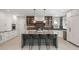 Modern kitchen features a large island with seating, stainless steel appliances, and stylish lighting at 18 Foxtail Cir, Englewood, CO 80113