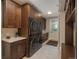 Convenient laundry room with ample storage and modern washer/dryer units at 18 Foxtail Cir, Englewood, CO 80113