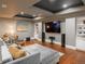 Spacious living room with large TV, recessed lighting, wood floors, and comfortable seating at 18 Foxtail Cir, Englewood, CO 80113