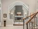 Open concept living room with a cozy fireplace, hardwood floors, and plenty of natural light at 18 Foxtail Cir, Englewood, CO 80113