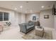 Cozy living room with a comfortable blue couch, decorative pillows, and a stained glass window at 18 Foxtail Cir, Englewood, CO 80113