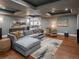 Spacious living room with hardwood floors, a large sectional sofa, and coffered ceilings at 18 Foxtail Cir, Englewood, CO 80113