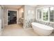The main bathroom has a standalone tub and leads to the walk-in closet and double sink at 18 Foxtail Cir, Englewood, CO 80113