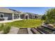 Spacious backyard with lush green lawn, outdoor fireplace, and raised garden beds at 3344 Carabiner St, Castle Rock, CO 80108