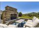 Outdoor stone fireplace with seating provides an inviting space for relaxation and entertainment at 3344 Carabiner St, Castle Rock, CO 80108
