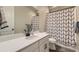 Cozy bathroom with a shower featuring a patterned curtain, a modern vanity, and stylish decor at 3344 Carabiner St, Castle Rock, CO 80108