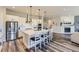 Bright kitchen with large island, seating, stainless steel appliances, subway tile backsplash, and hardwood floors at 3344 Carabiner St, Castle Rock, CO 80108